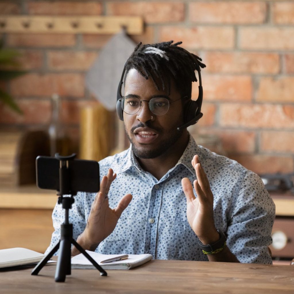 Young man filming himself with cellphone