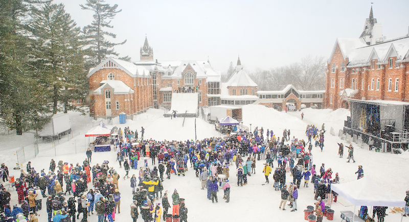 Winterfest celebration in the quad with many students gathered in the snow.