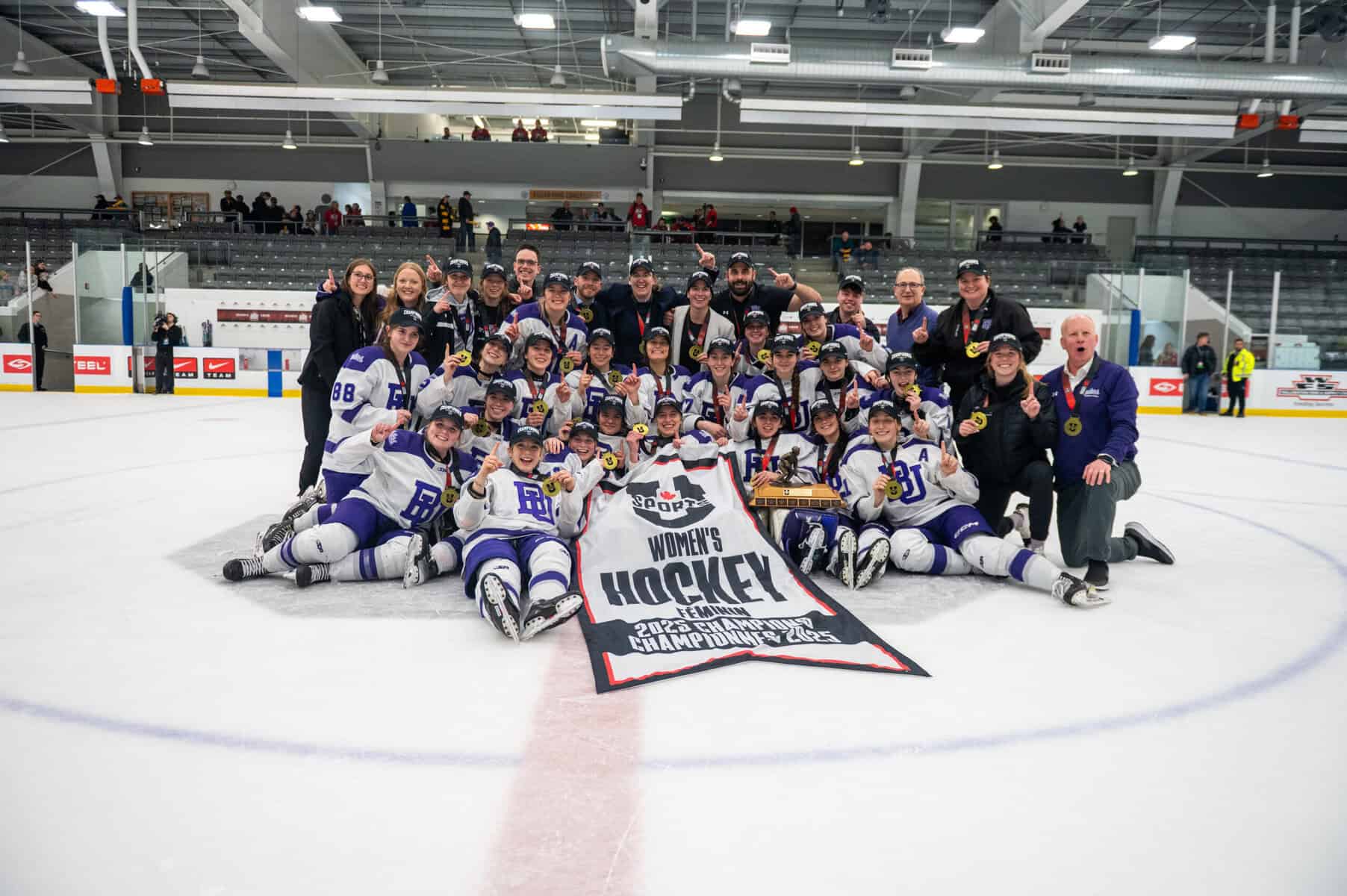 Bishop's Women's Hockey team with National Championship Banner