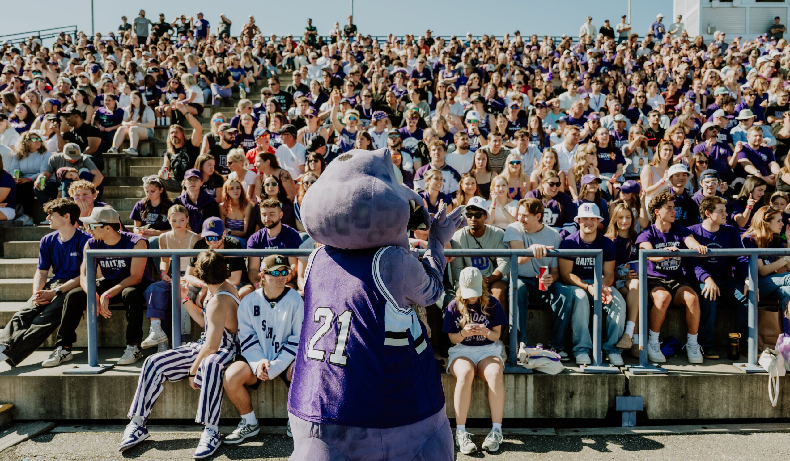 Gaiter mascot in front of homecoming football crowd