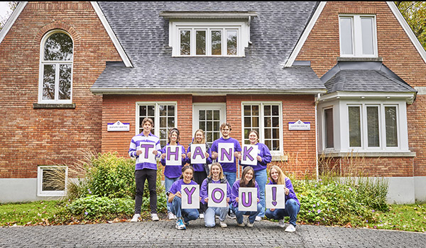 Bishop's students saying thank you using signs.