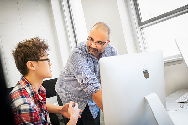Student and professor having a discussion.