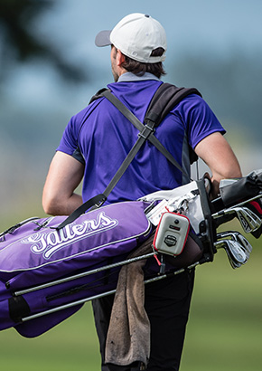 Student carying his golf clubs