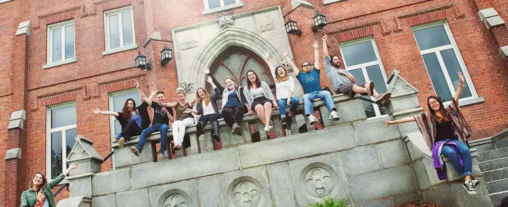 Students on the balcony of McGreer expressing joy