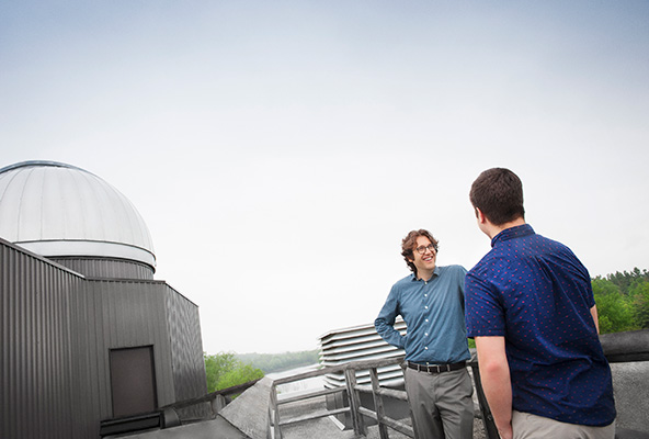 Dr. Jason Rowe next to the Bishop's Observatory