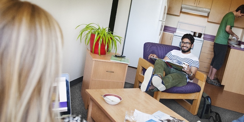 Students laugh and relax in their dorm accommodations at Bishop's University.