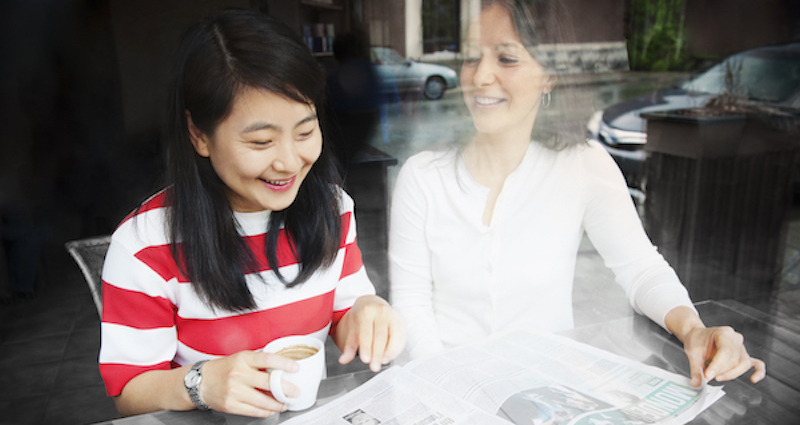 A Bishop's student and a professor talk over coffee and a paper.