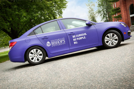 BU purple car with our logo and slogan "Be Curious, Be Purple, BU".