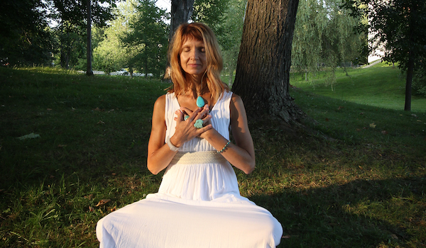 person meditating outside