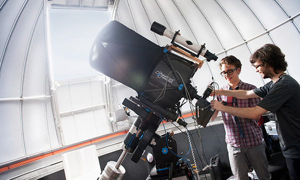 Students using telescope